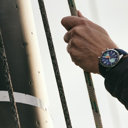 A man pulling a rope wearing the new TAG Heuer chronographic watch.