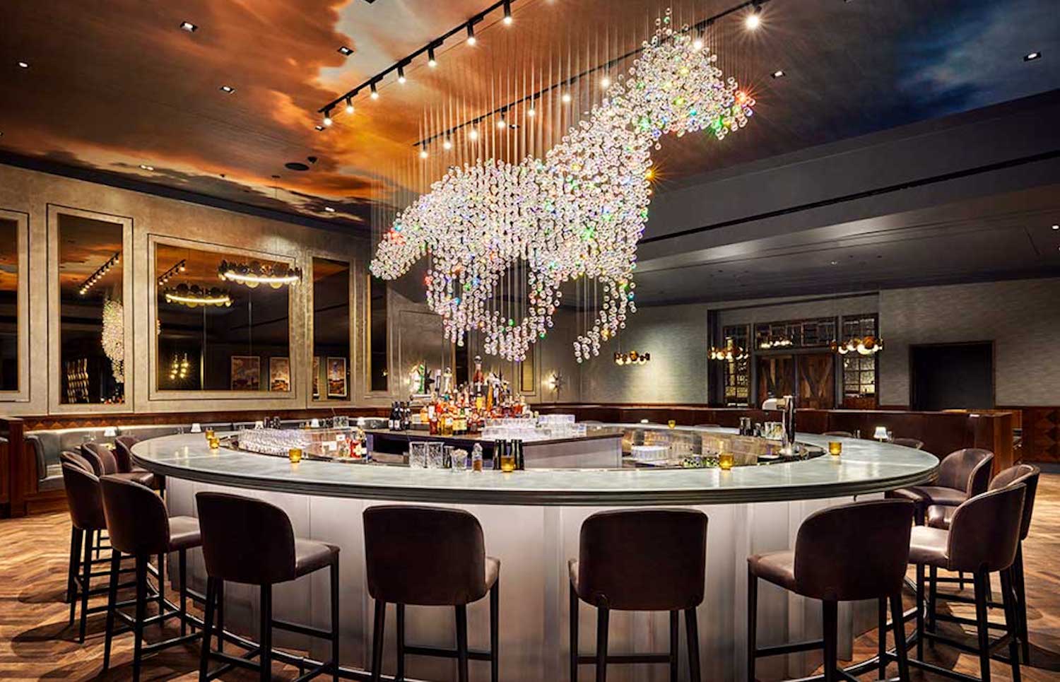 Horse-shapes crystal chandelier at the center of a round bar