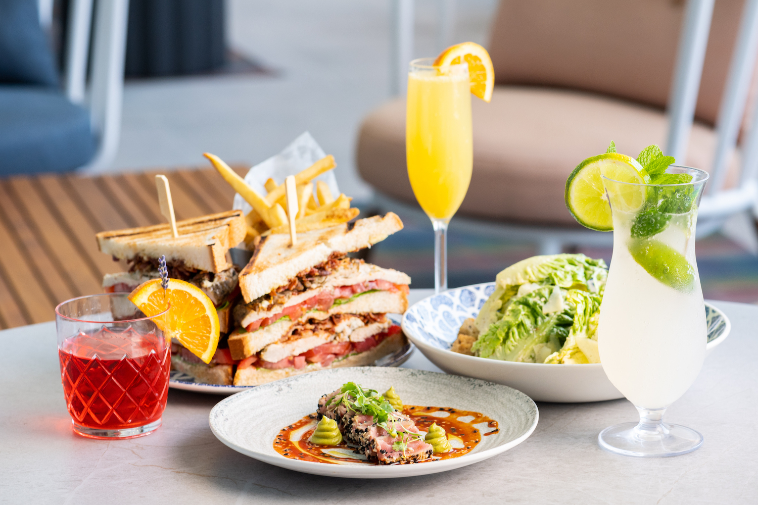Sandwich and sides with mimosas and cocktails