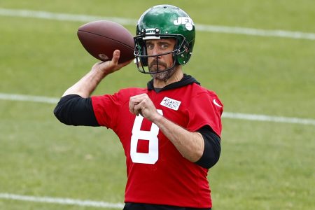 Aaron Rodgers of the New York Jets throws a pass at OTAs