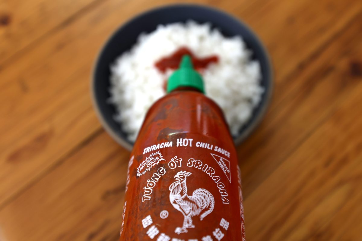A bottle of Huy Fong Foods sriracha sauce.