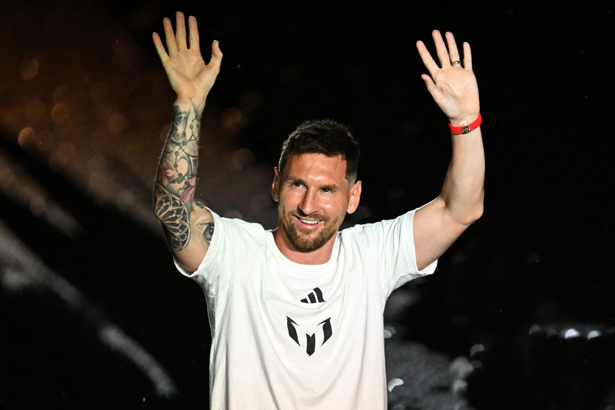 Lionel Messi waves as he is presented as the newest MLS player.