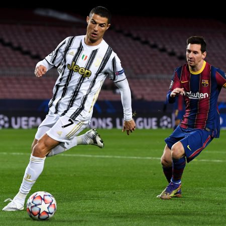 Cristiano Ronaldo is put under pressure by Lionel Messi in a Champions League match in 2020.