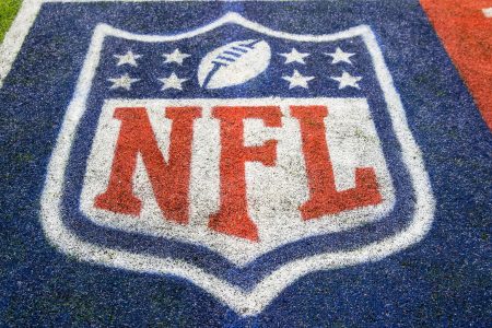An NFL logo on the field.