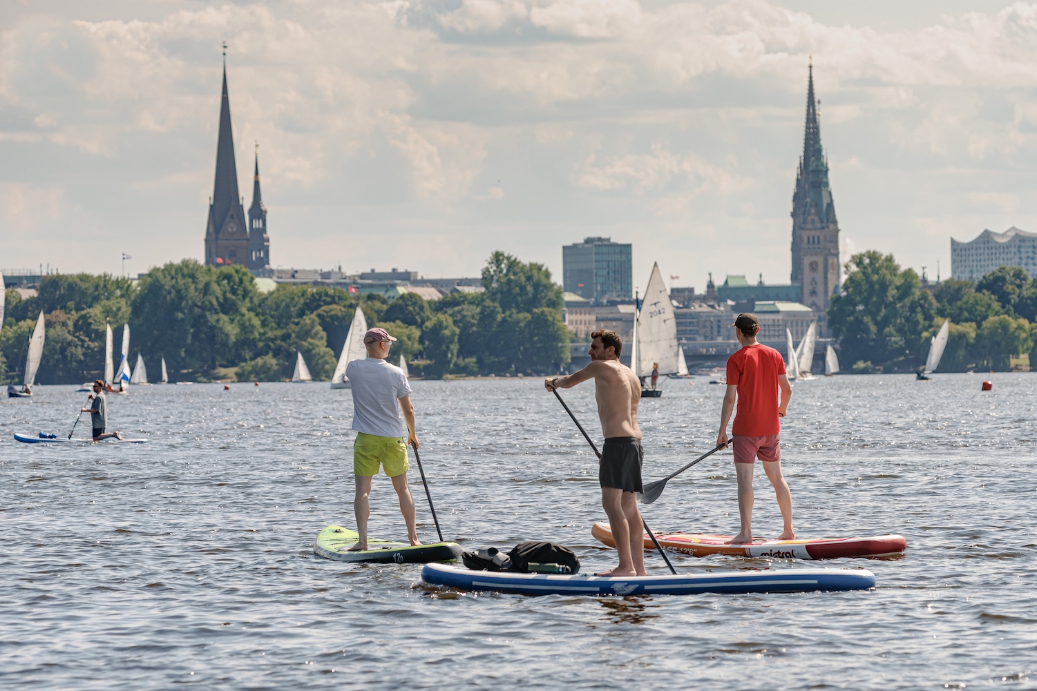 A trio of men on paddleboards in Germany.