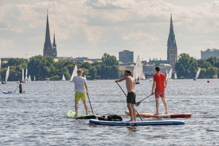 A trio of men on paddleboards in Germany.