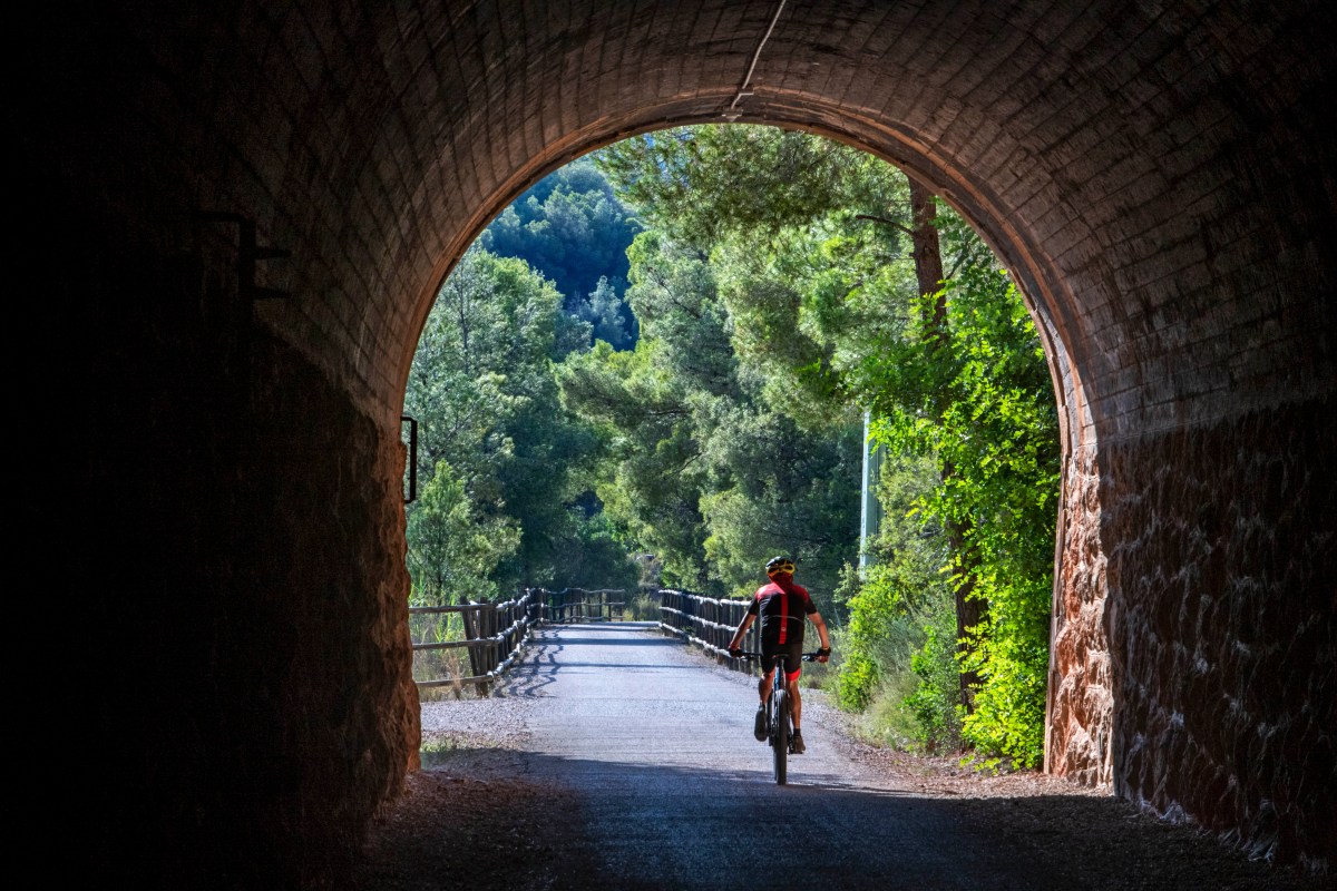 Cycling on the Val de Zafán greenway between Bot and Xerta villages (Tarragona, Catalonia, Spain). 