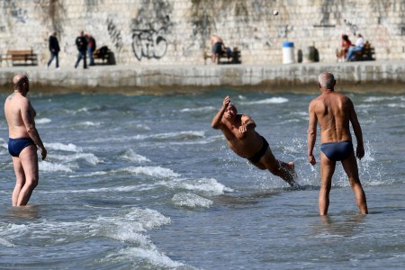 A group of men play a game called "Picigin" on Bacvice Beach along the Croatian coastline.