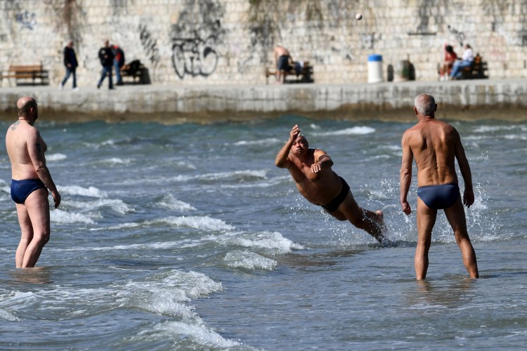 A group of men play a game called "Picigin" on Bacvice Beach along the Croatian coastline.