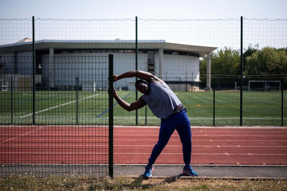 Republic of the Congo's shot put athlete Franck Elemba stretches during a training session on July 24, 2019 in Eaubonne, on the outskirts of Paris. - Fourth during the 2016 Rio Games, the impressive Congolese shot put Franck Elemba dreams of wearing the colors of the French team for the 2024 Paris Games, after a tortuous course marked by a precarious status. (Photo by Lionel BONAVENTURE / AFP) (Photo credit should read LIONEL BONAVENTURE/AFP via Getty Images)