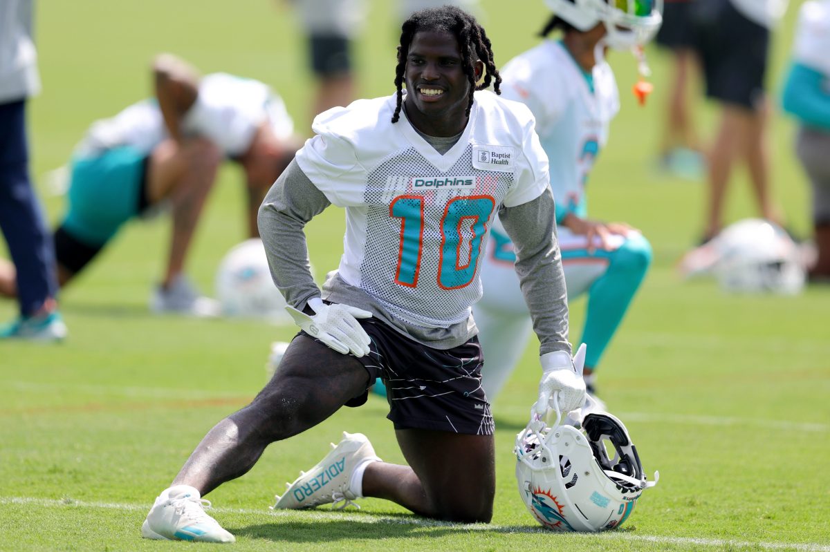 Tyreek Hill of the Miami Dolphins stretches prior to a practice.