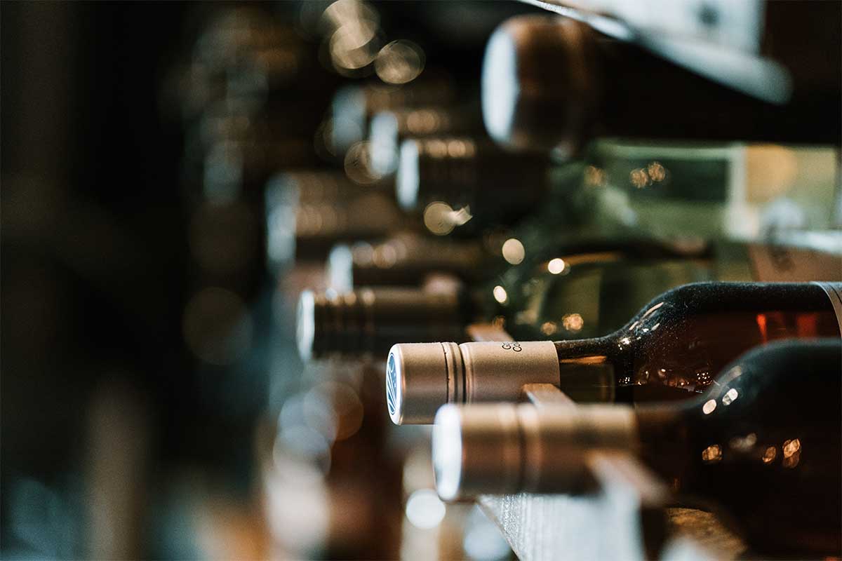 Bottles of alcohol on a rack. Wine and whisky investment is growing a trade-able asset.