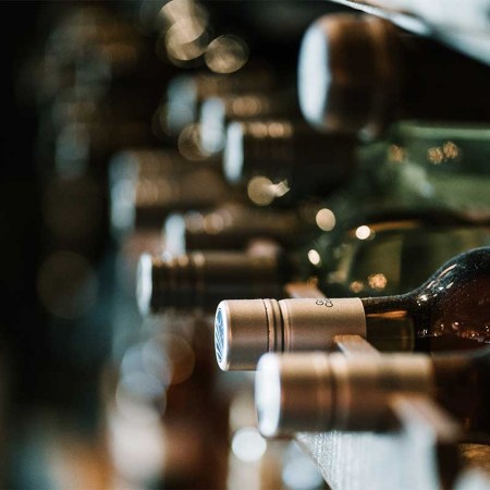 Bottles of alcohol on a rack. Wine and whisky investment is growing a trade-able asset.