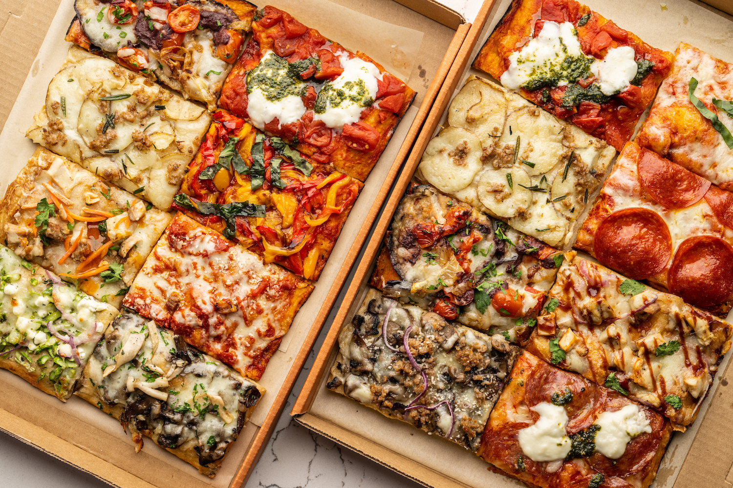 slices of rectangular-sliced pizza with a variety of different toppings