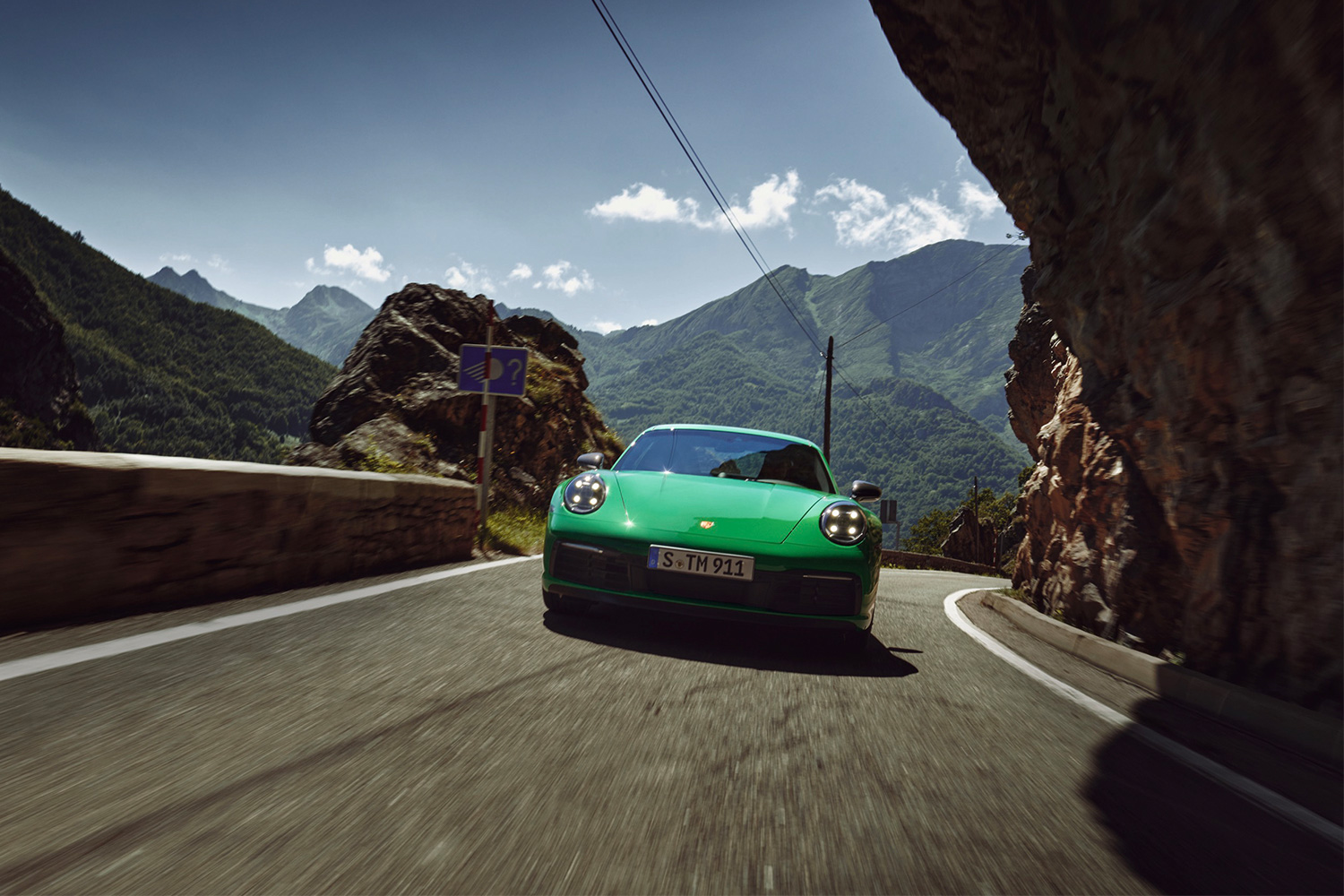 2023 Porsche 911 Carrera T driving through the mountains