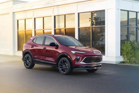 Front 3/4 view of the 2024 Buick Encore GX ST in Cinnabar Metallic. Preproduction model shown. Actual production model may vary. Available in Spring 2023.