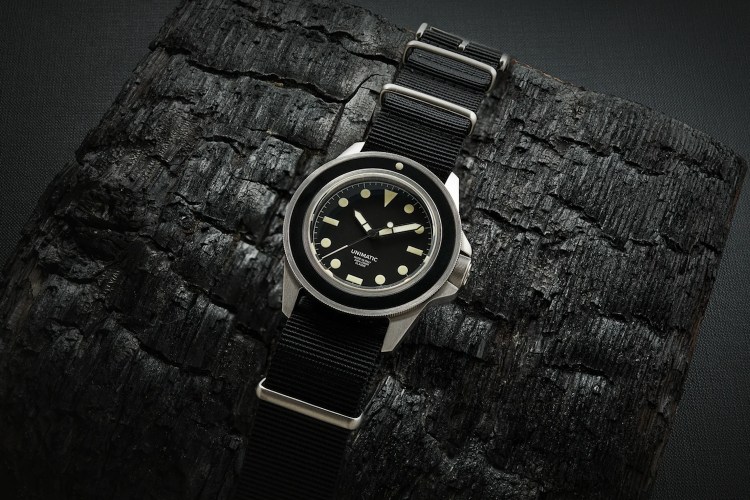 A Unimatic watch on a black background