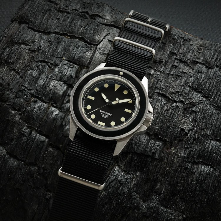A Unimatic watch on a black background