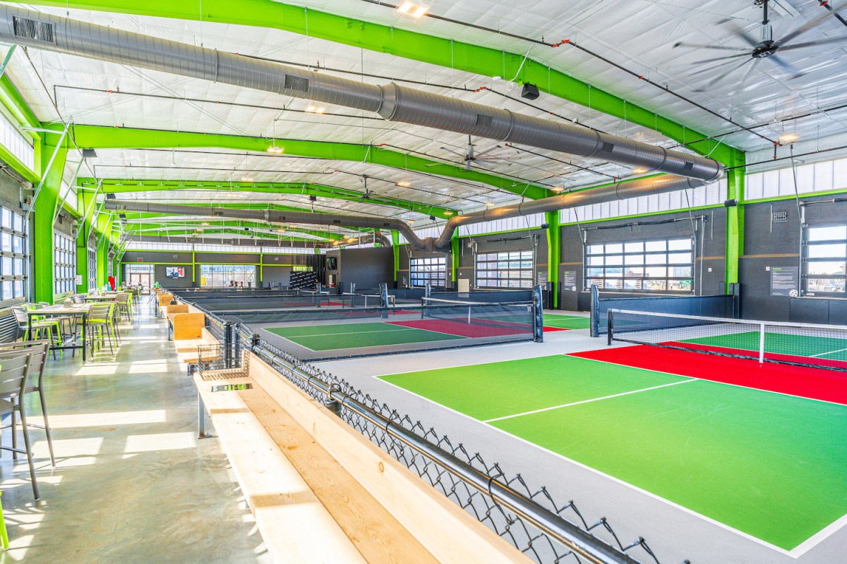 Neon green indoor pickleball courts at Chicken N Pickle in Texas
