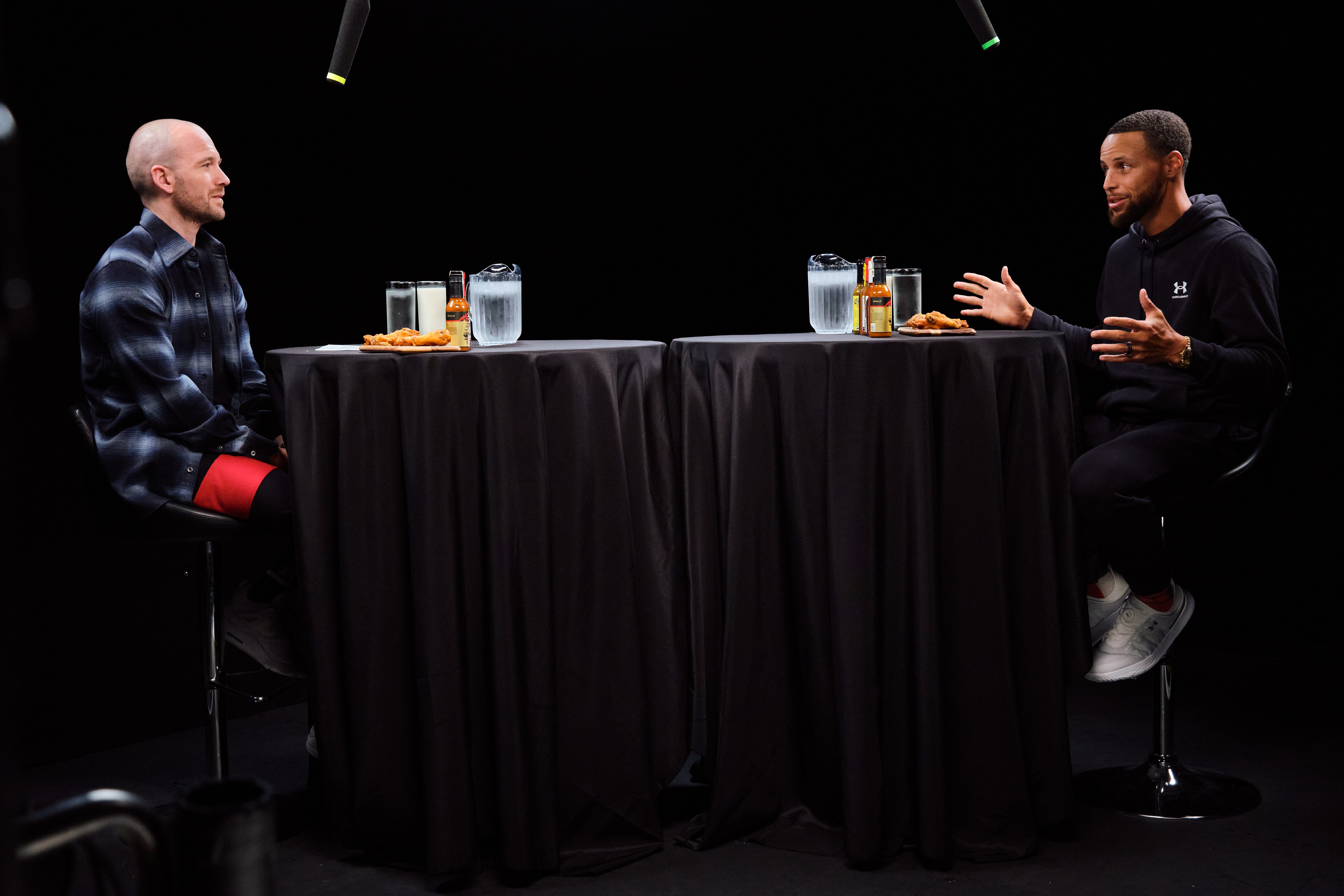 "Hot Ones" host Sean Evans with Steph Curry.