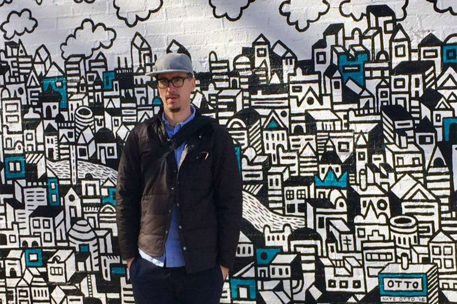 Local Chicago artist Nate Otto in front of mural