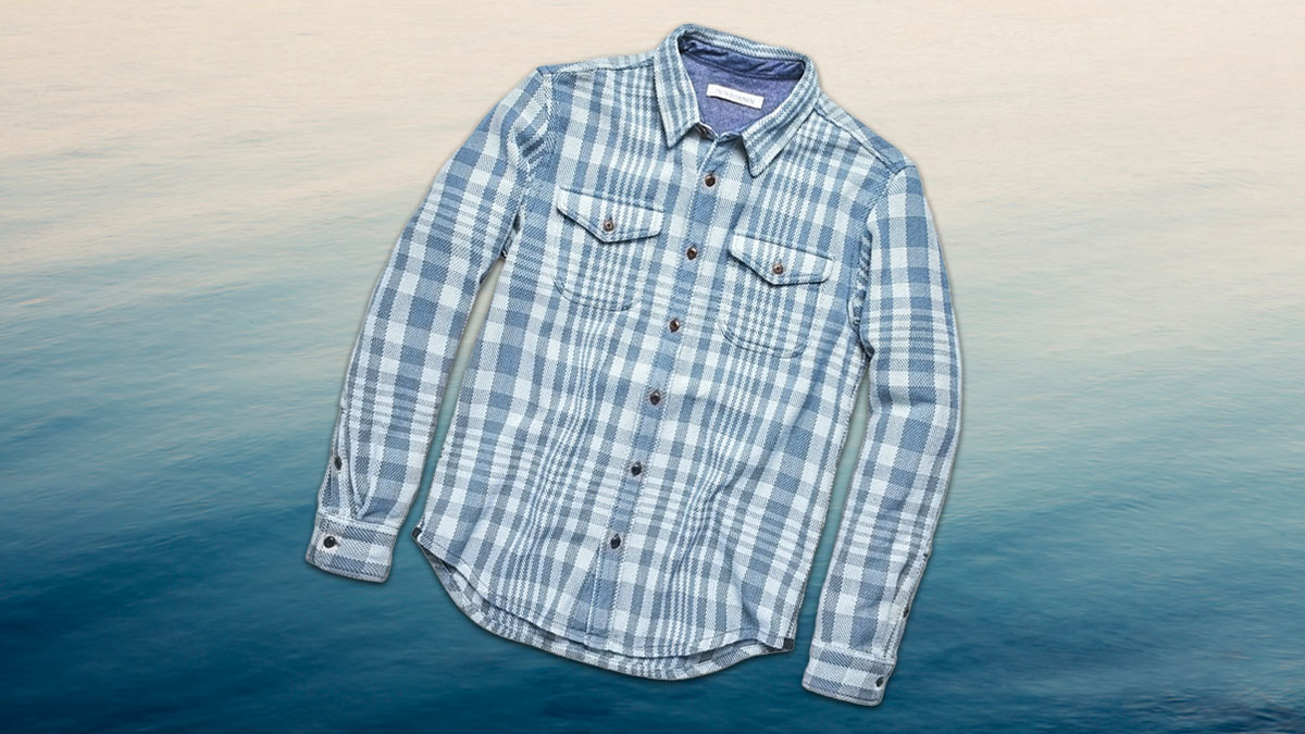 a blue Outerknown Blanket Shirt on a sea background
