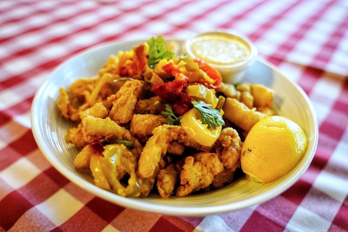 rhode island style calamari in a white bowl on a white and red checkered tablecloth