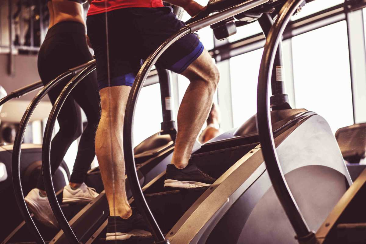 A view of a man's calves as he climbs the StairMaster.