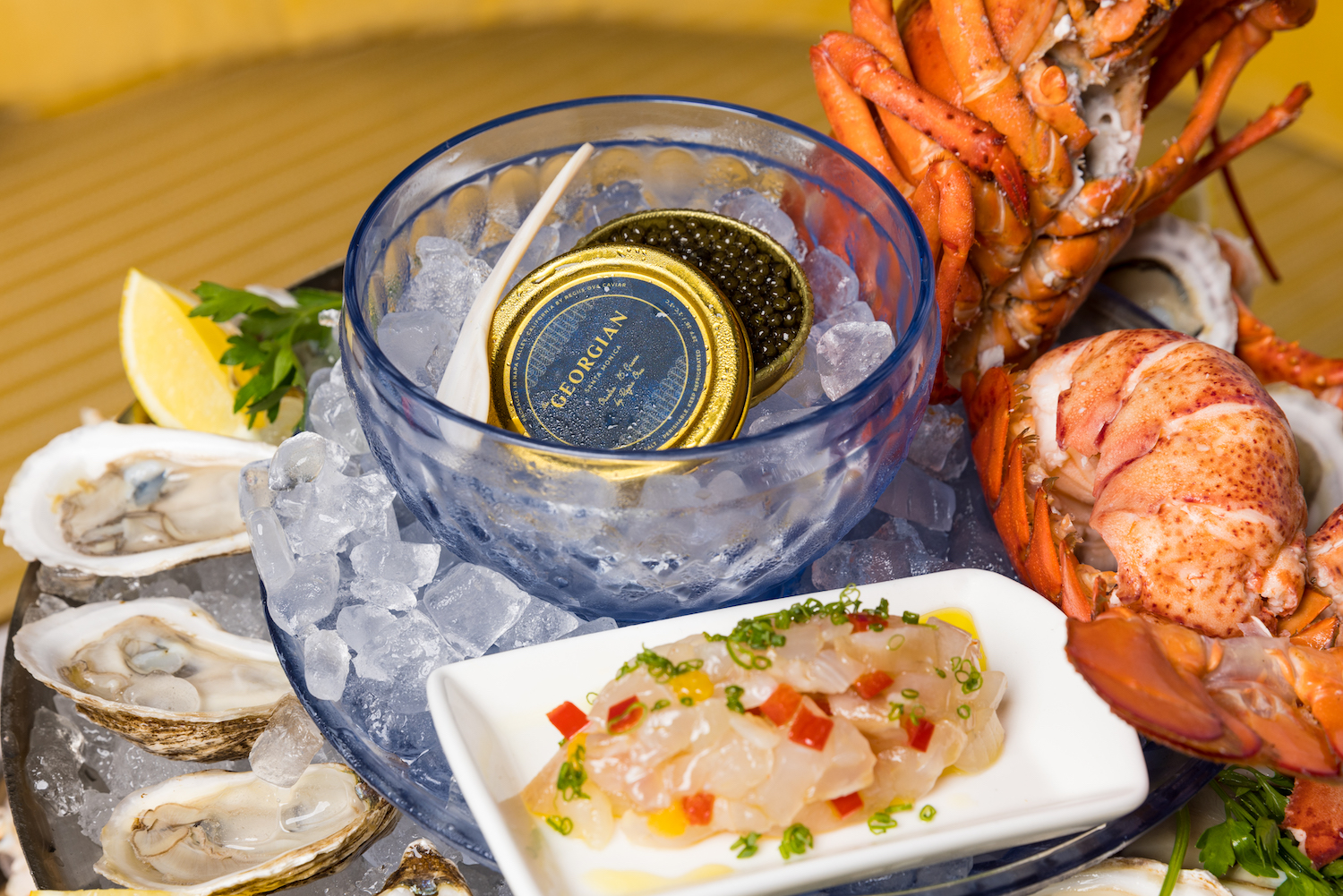Caviar at the center of a raw bar polatter featuring various seafoods