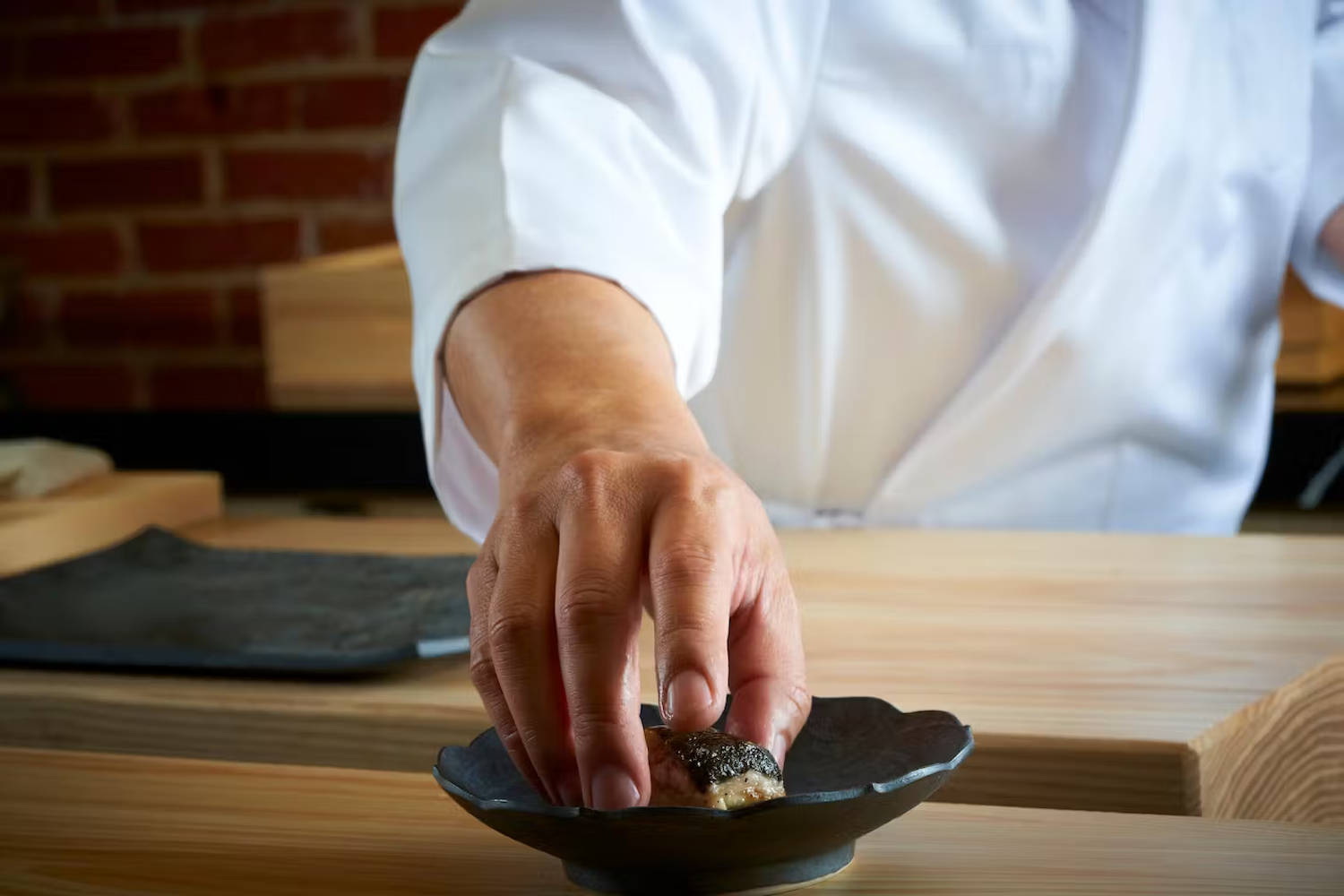 Sushi in a bowl being prepared by chef