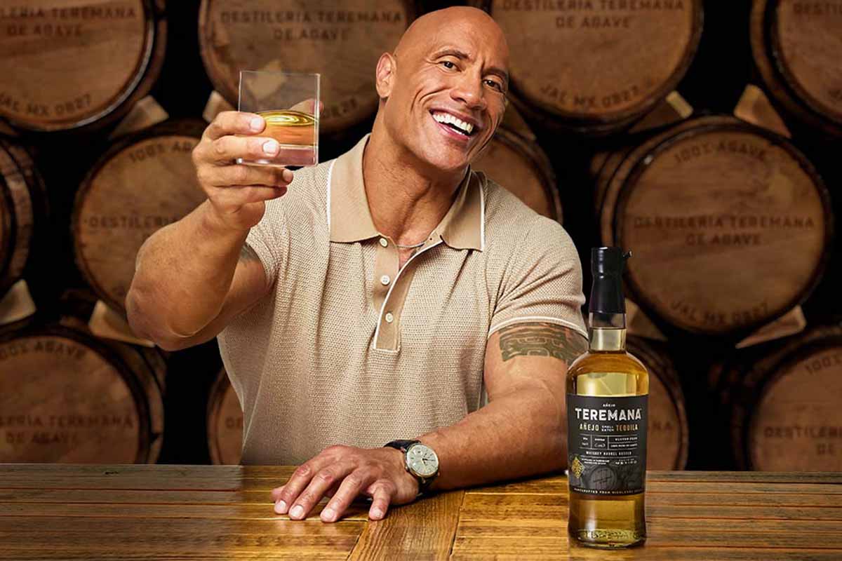 Dwayne Johnson and his Teremana tequila in front of barrels