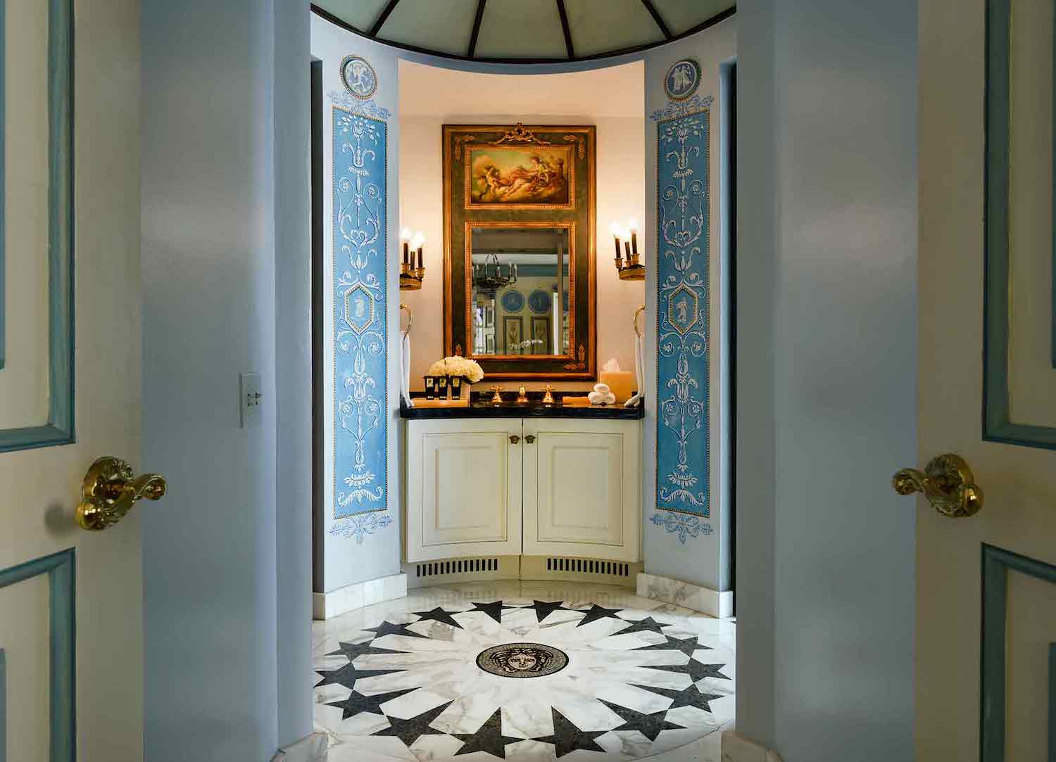 Interior walkway with a sink, blue and white designs and an old painting