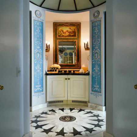 Interior walkway with a sink, blue and white designs and an old painting