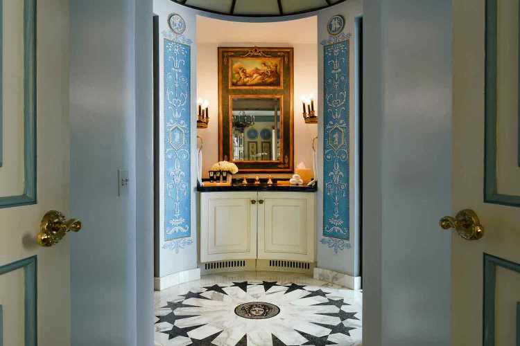 Interior walkway with a sink, blue and white designs and an old painting
