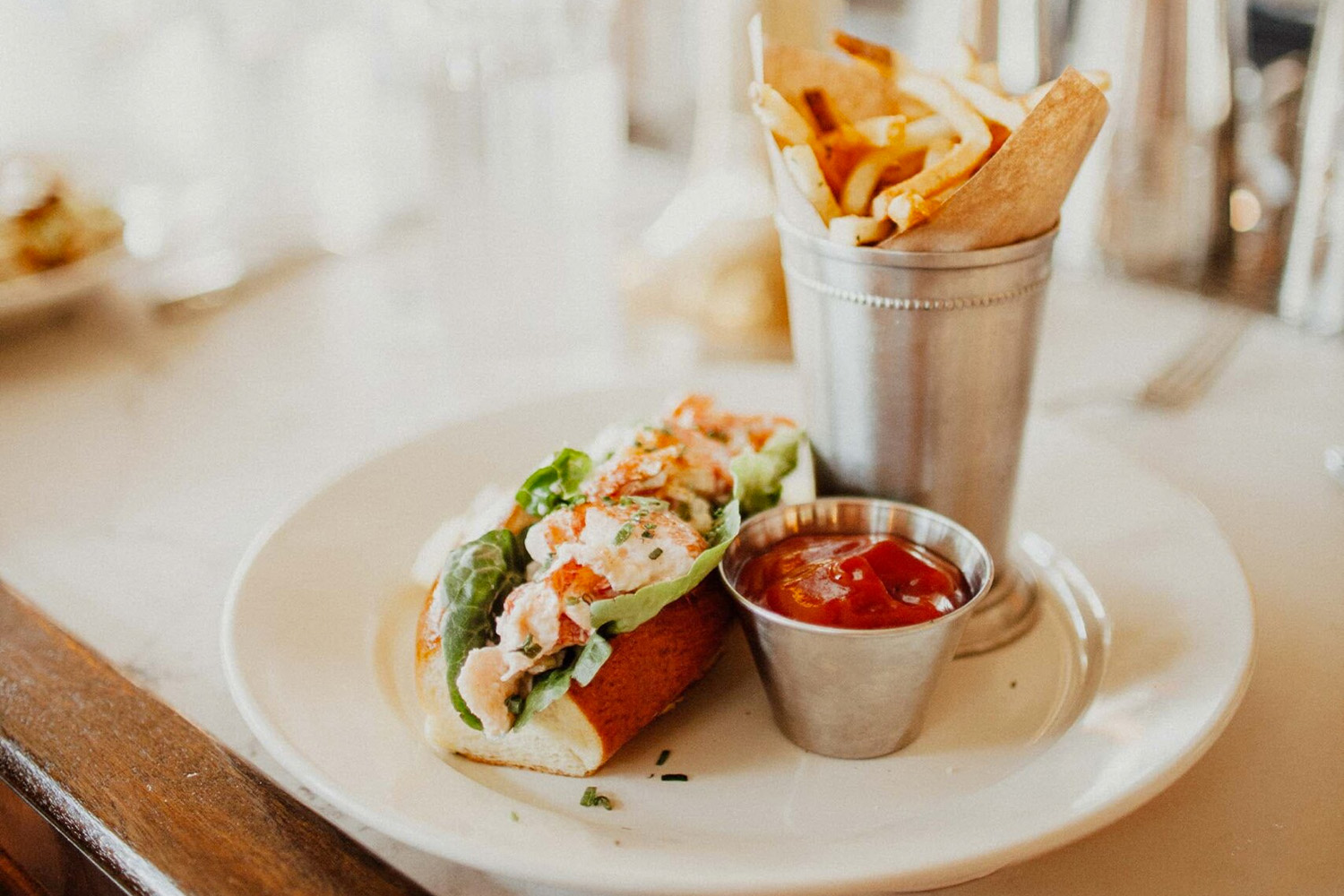 Lobster roll and fries on a plate