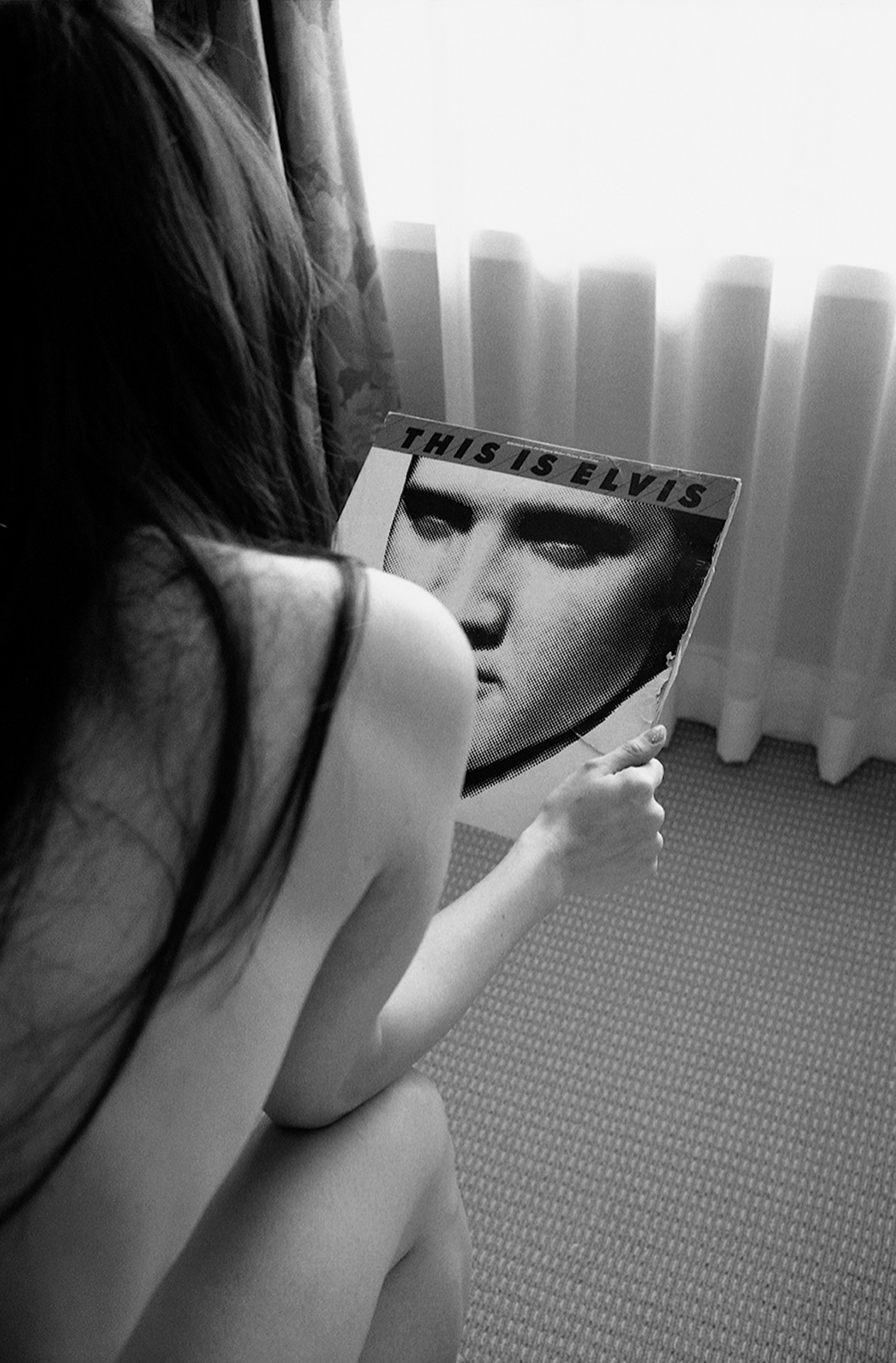 Woman looking at an Elvis album