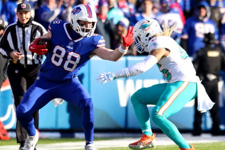 Dawson Knox of the Buffalo Bills carries the ball against the Miami Dolphins.