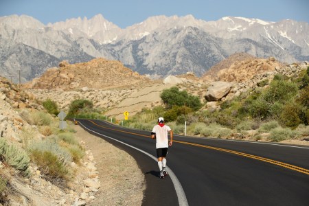 A man running on the road in the heat.