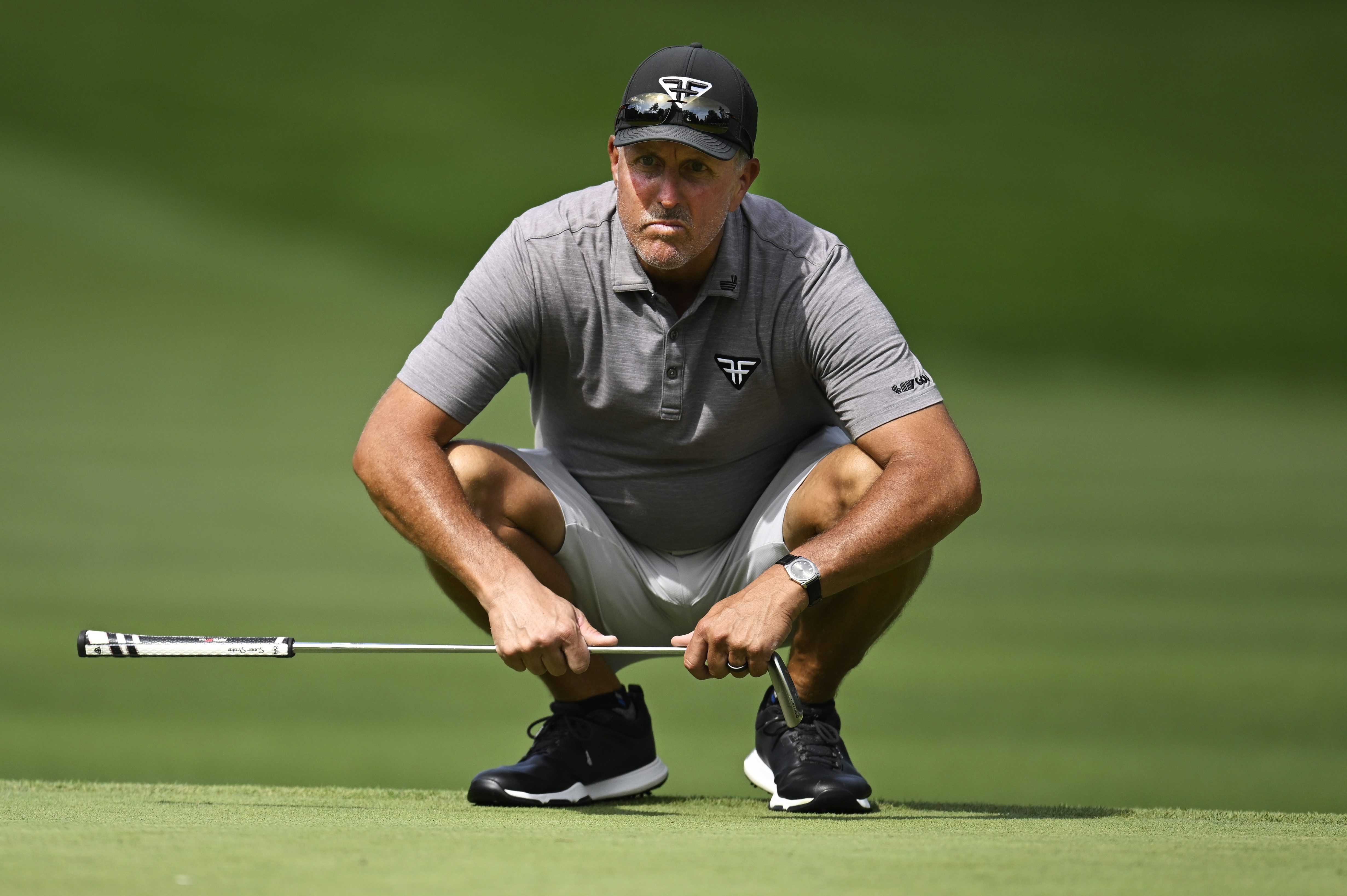 Phil Mickelson lines up a putt at the LIV Golf Invitational.