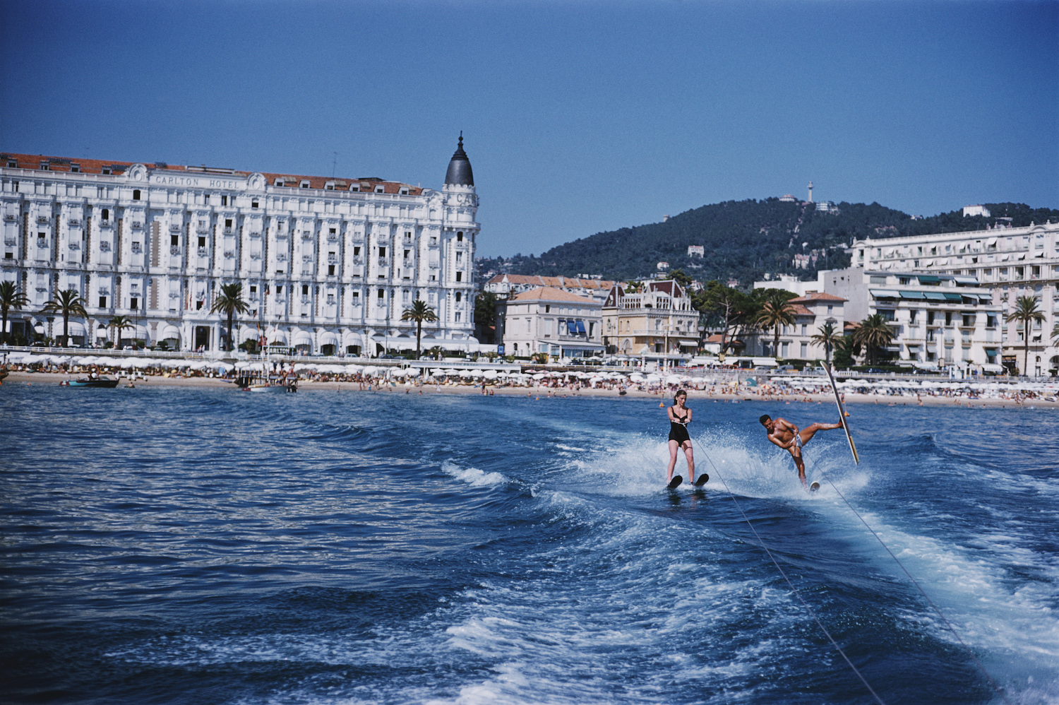 A man and woman on water skis off the coast of Cannes.