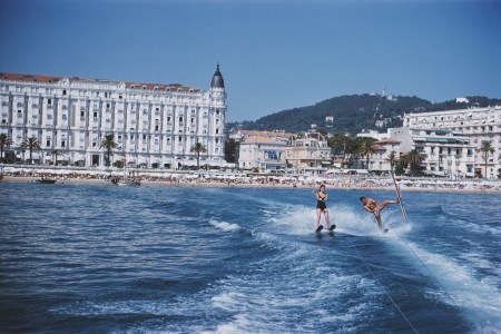 A man and woman on water skis off the coast of Cannes.