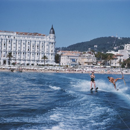 A man and woman on water skis off the coast of Cannes.