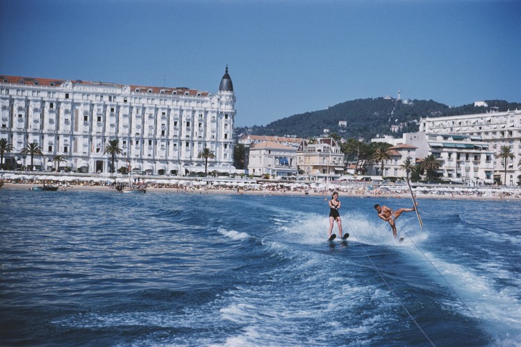 A man and woman on water skis off the coast of Cannes.
