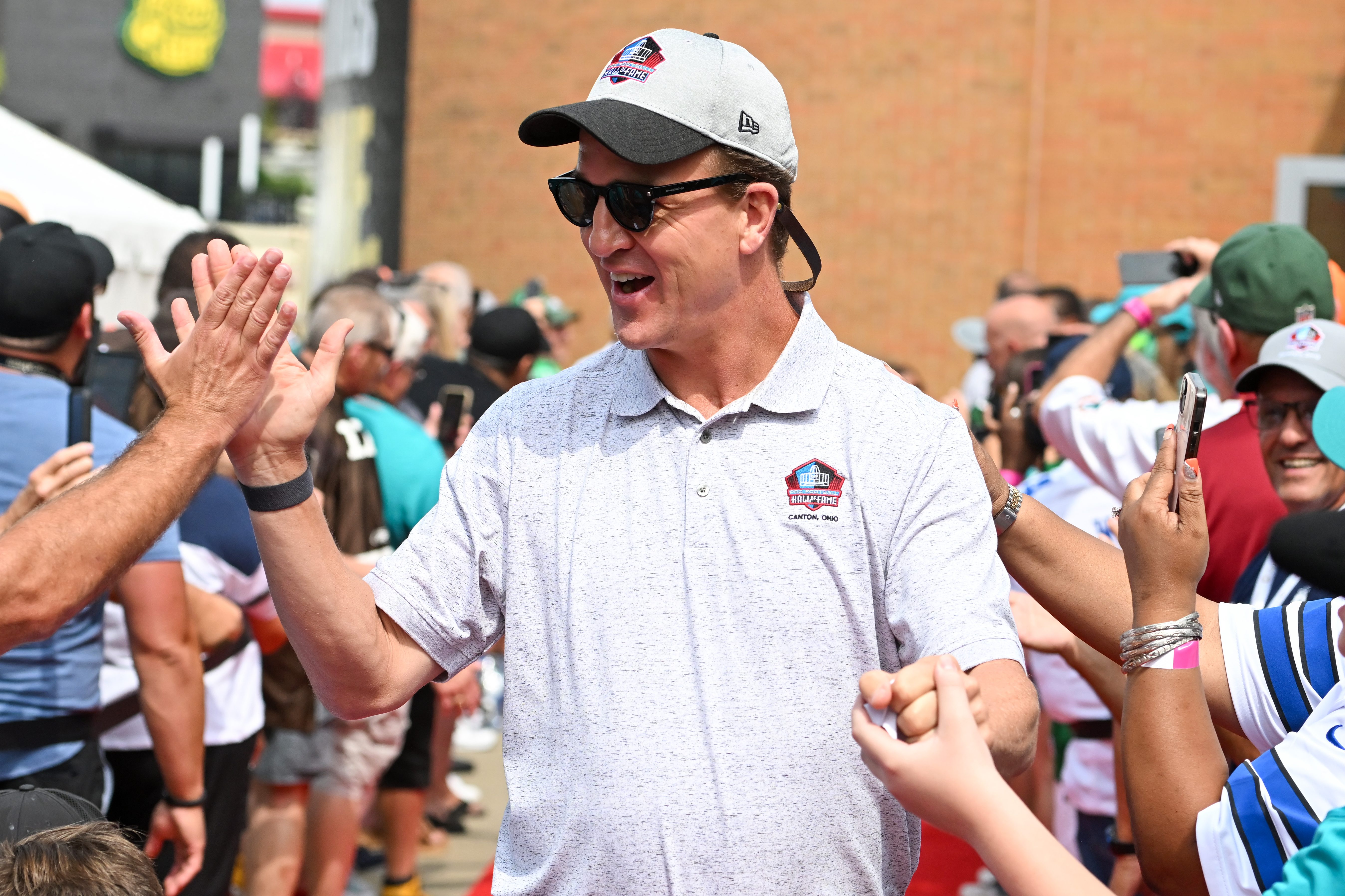 Peyton Manning celebrates with fans at the Hall of Fame in Ohio.