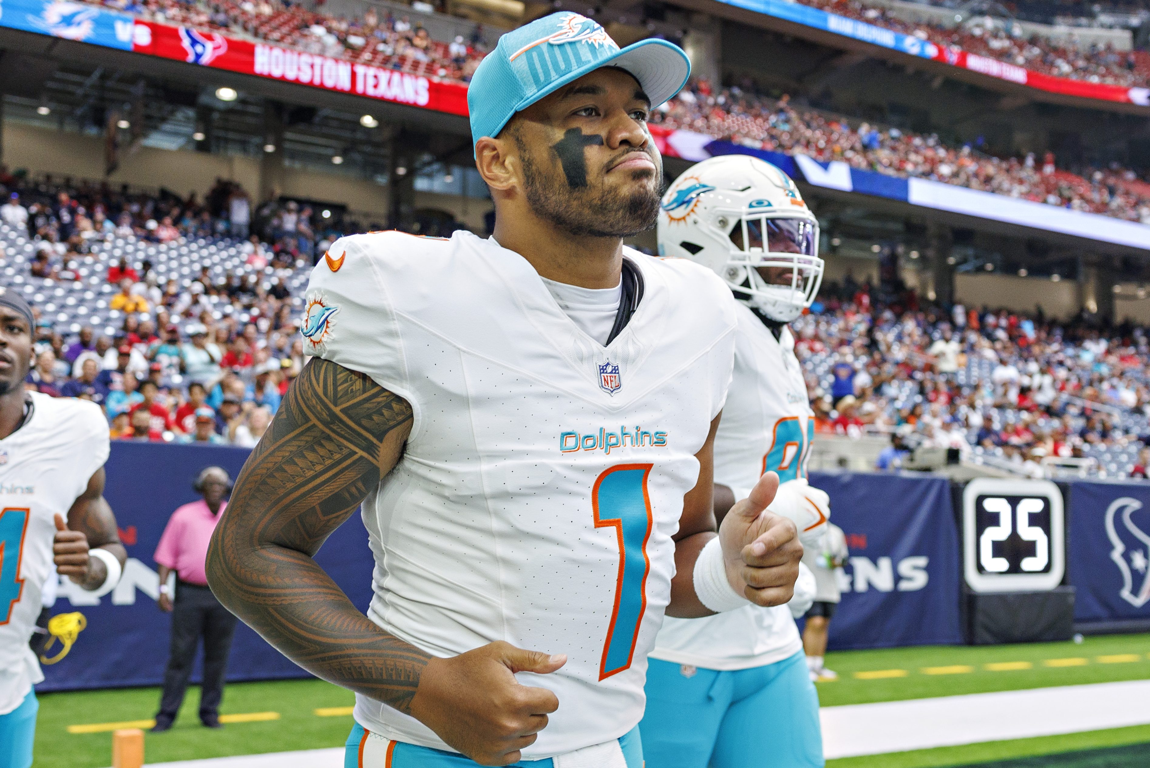 Tua Tagovailoa of the Dolphins jogs onto the field.