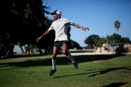 A view of Meb Keflezighi doing dynamic warm-ups before a run.