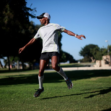 A view of Meb Keflezighi doing dynamic warm-ups before a run.