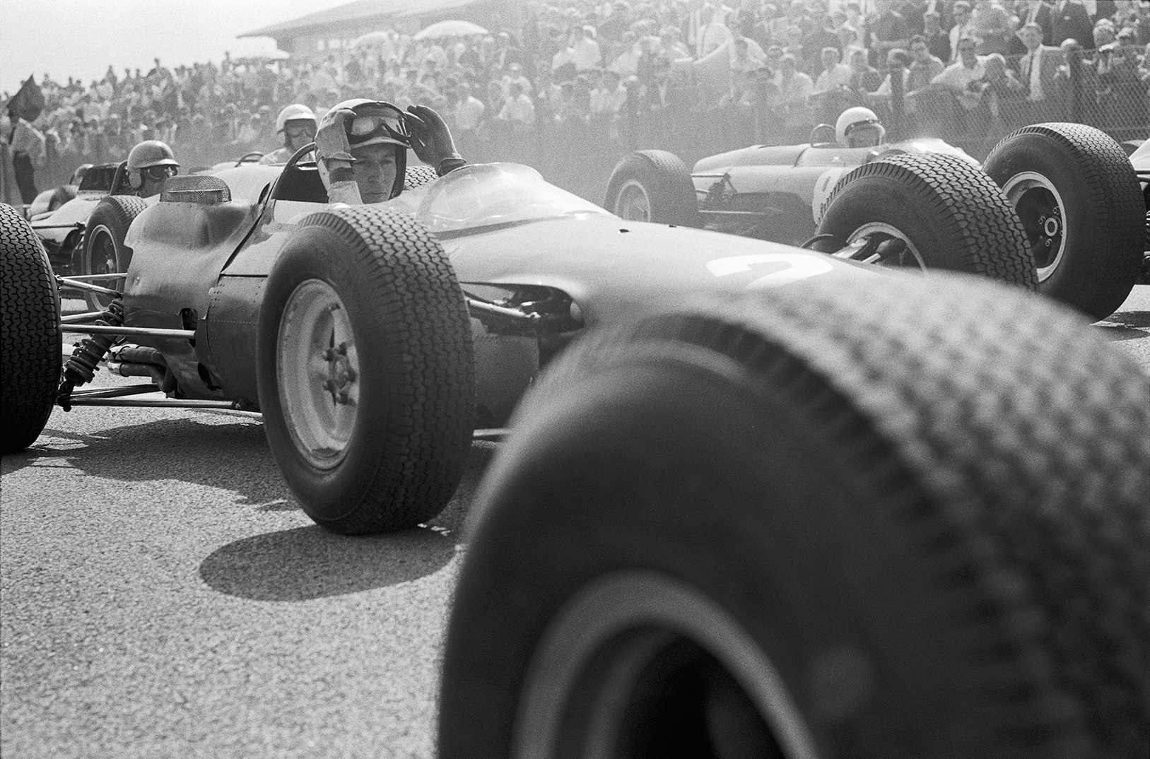  "John Surtees in the thick of the action at the Dutch GP in 1964. Amazing access so close to the cars at the start."