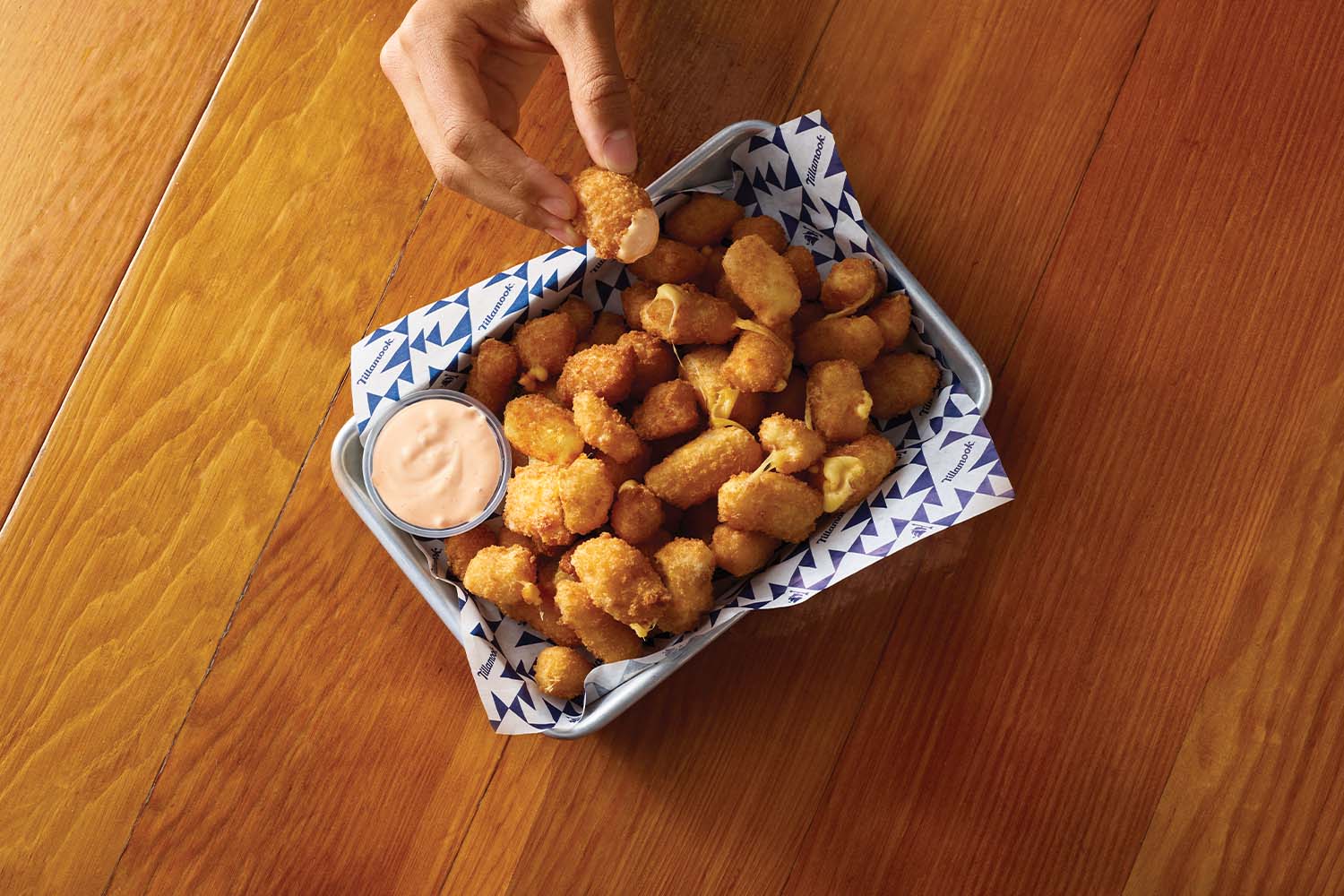 Cheese curds are served with a spicy cheddar chili ranch