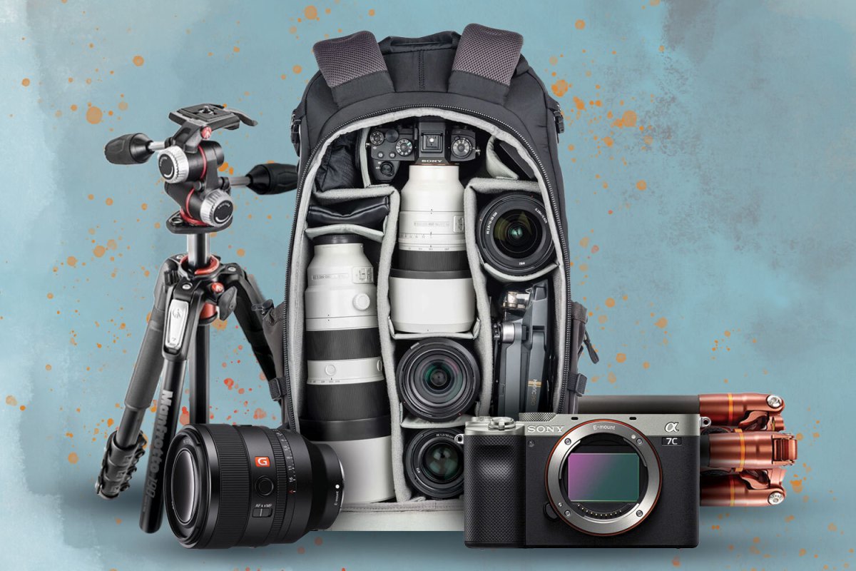A tripod, camera lens, camera backpack, lighting and camera gear
